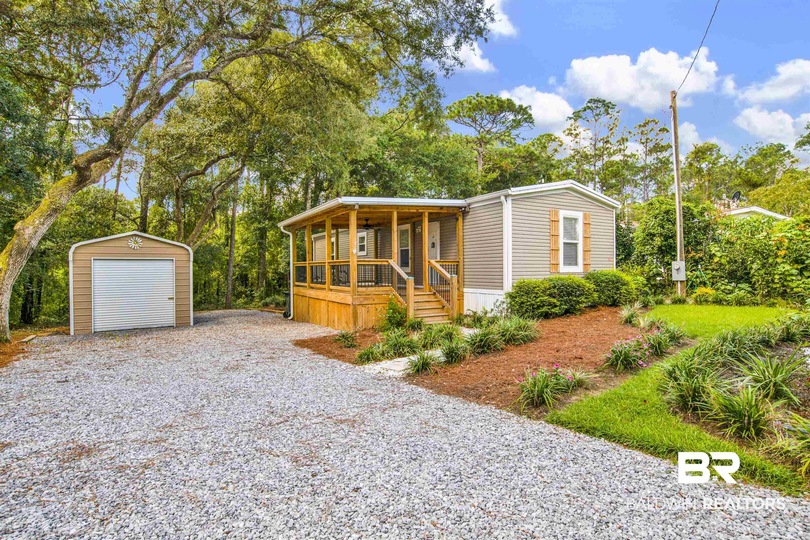 1411 Ridgewood Drive Lillian, AL 36549 - Photo 1 of 30 Manufactured / mobile home with an outdoor structure, a garage, and covered porch