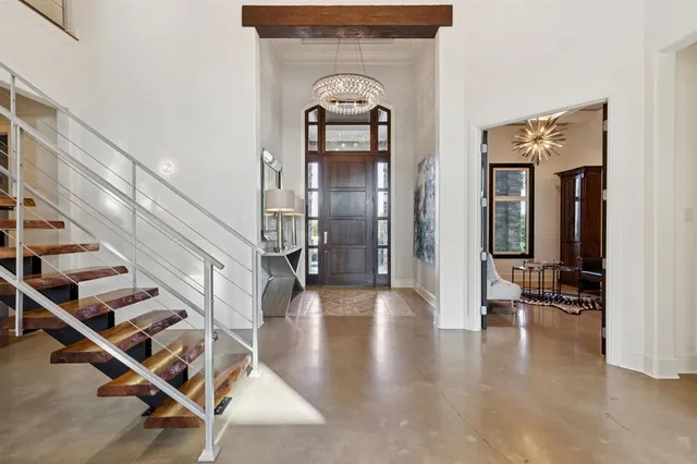 a view of a hallway with wooden floor and entryway