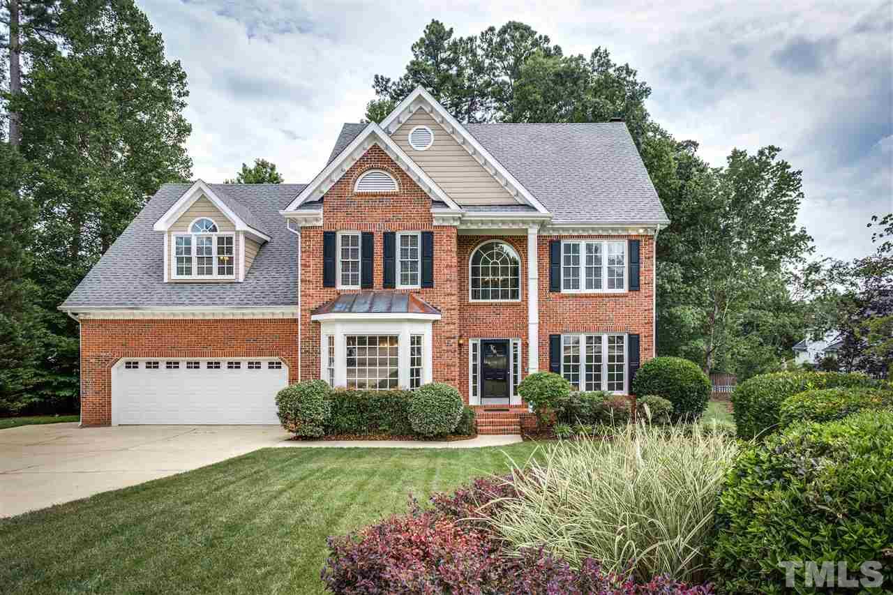 8401 Largo Springs Court Raleigh, NC 27613 - Photo 1 of 25 a front view of a house with a yard and garage