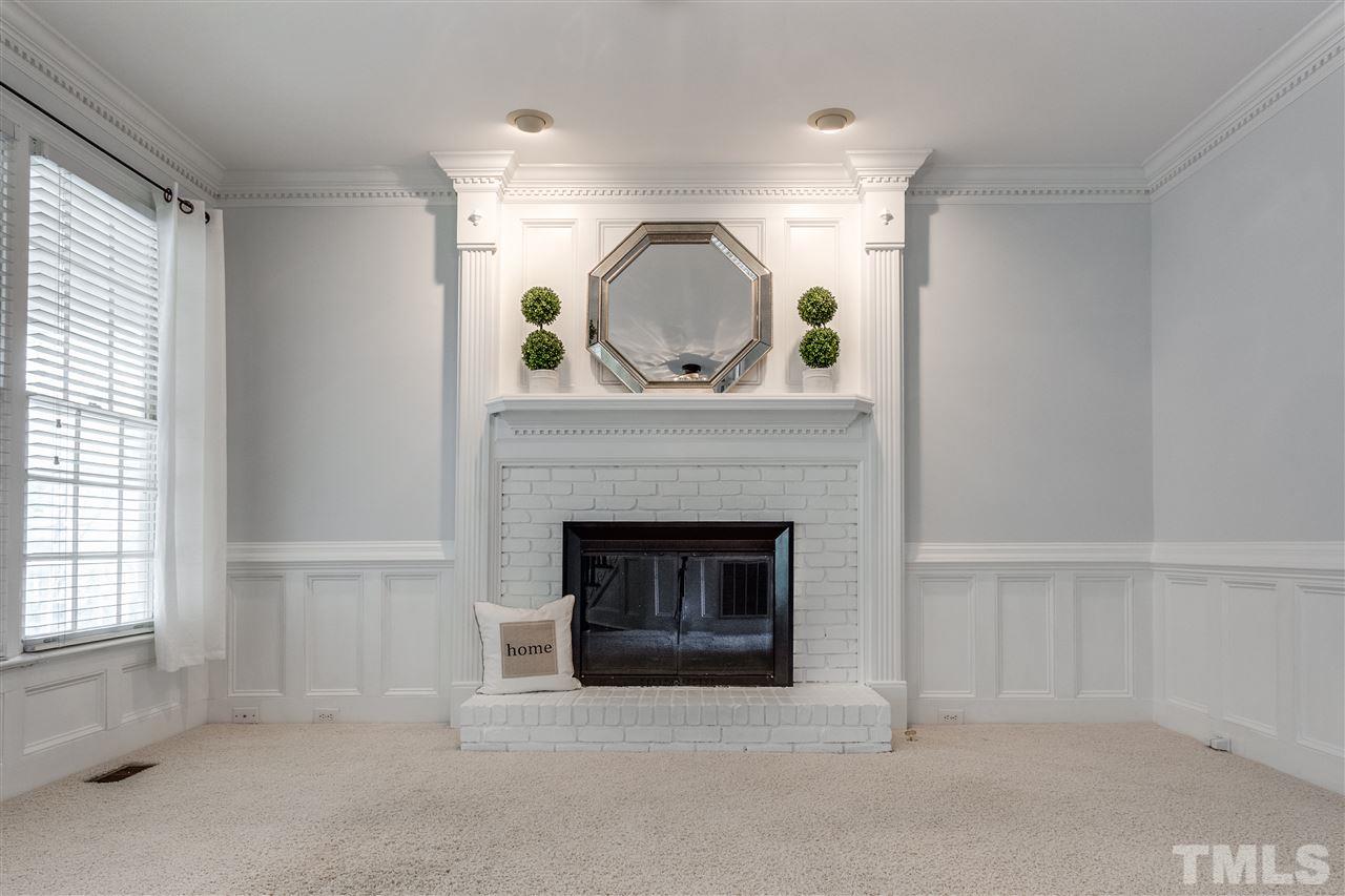 8401 Largo Springs Court Raleigh, NC 27613 - Photo 13 of 25 a living room with furniture and a fireplace