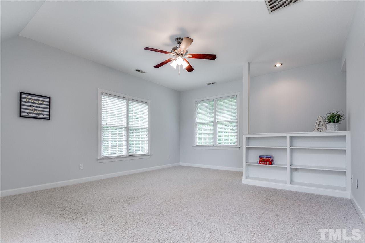8401 Largo Springs Court Raleigh, NC 27613 - Photo 16 of 25 a view of room with a ceiling fan and window