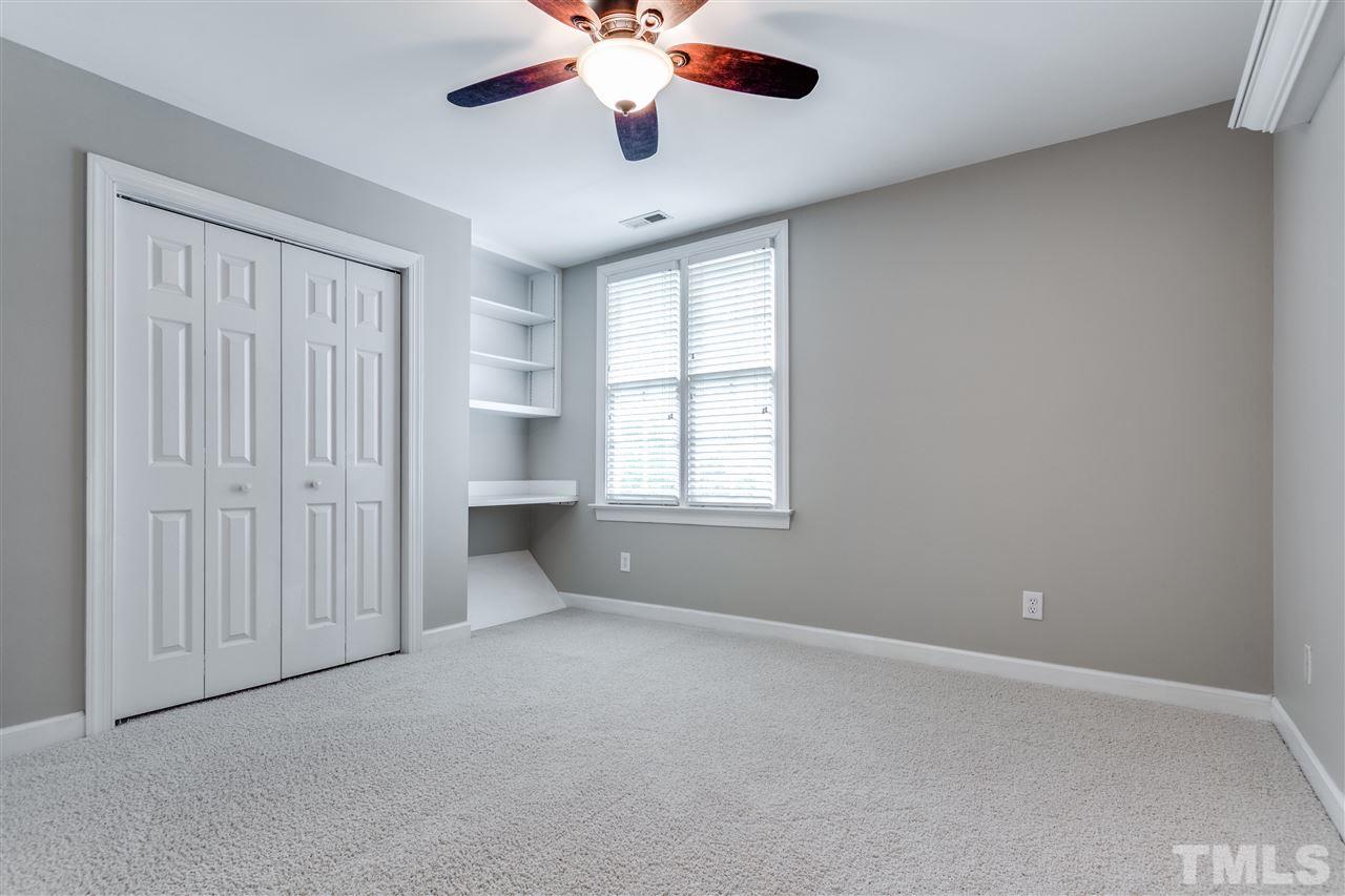 8401 Largo Springs Court Raleigh, NC 27613 - Photo 17 of 25 an empty room with chandelier fan and windows