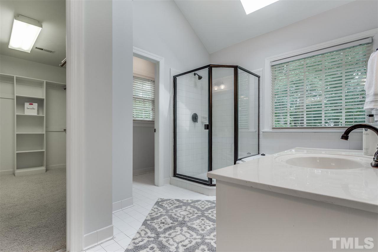 8401 Largo Springs Court Raleigh, NC 27613 - Photo 21 of 25 a spacious bathroom with a tub and a sink
