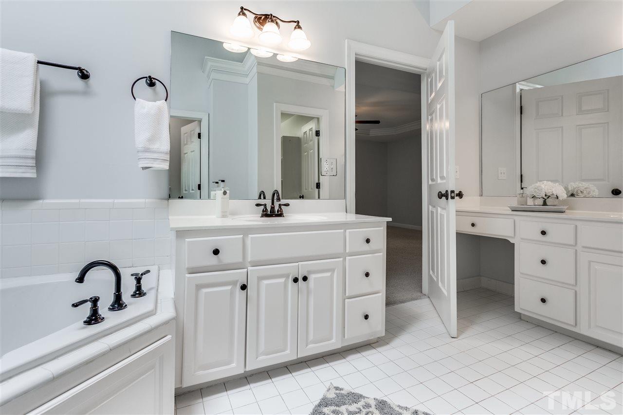 8401 Largo Springs Court Raleigh, NC 27613 - Photo 22 of 25 a bathroom with a double vanity sink mirror and