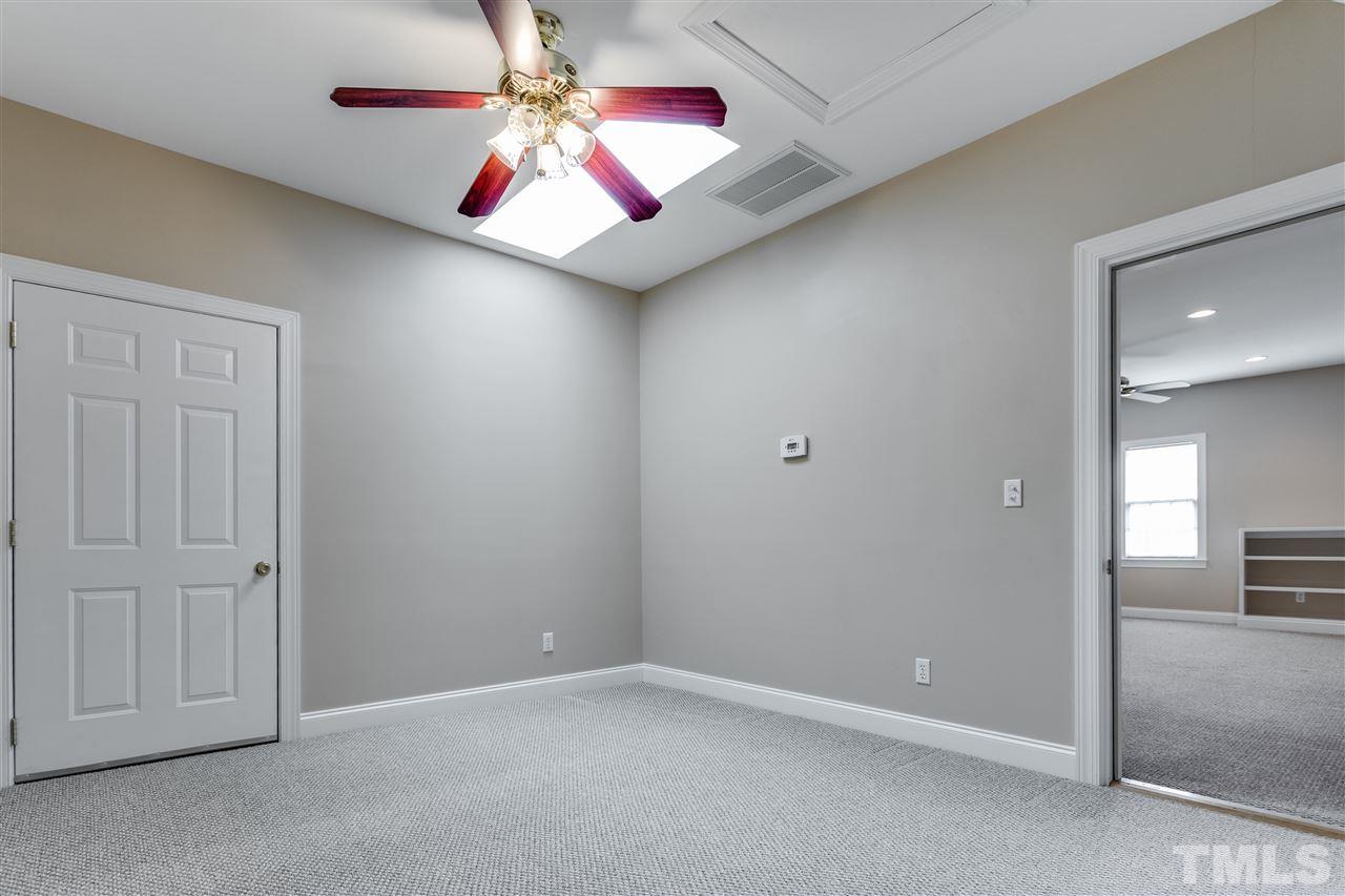 8401 Largo Springs Court Raleigh, NC 27613 - Photo 24 of 25 an empty room with closet and fan