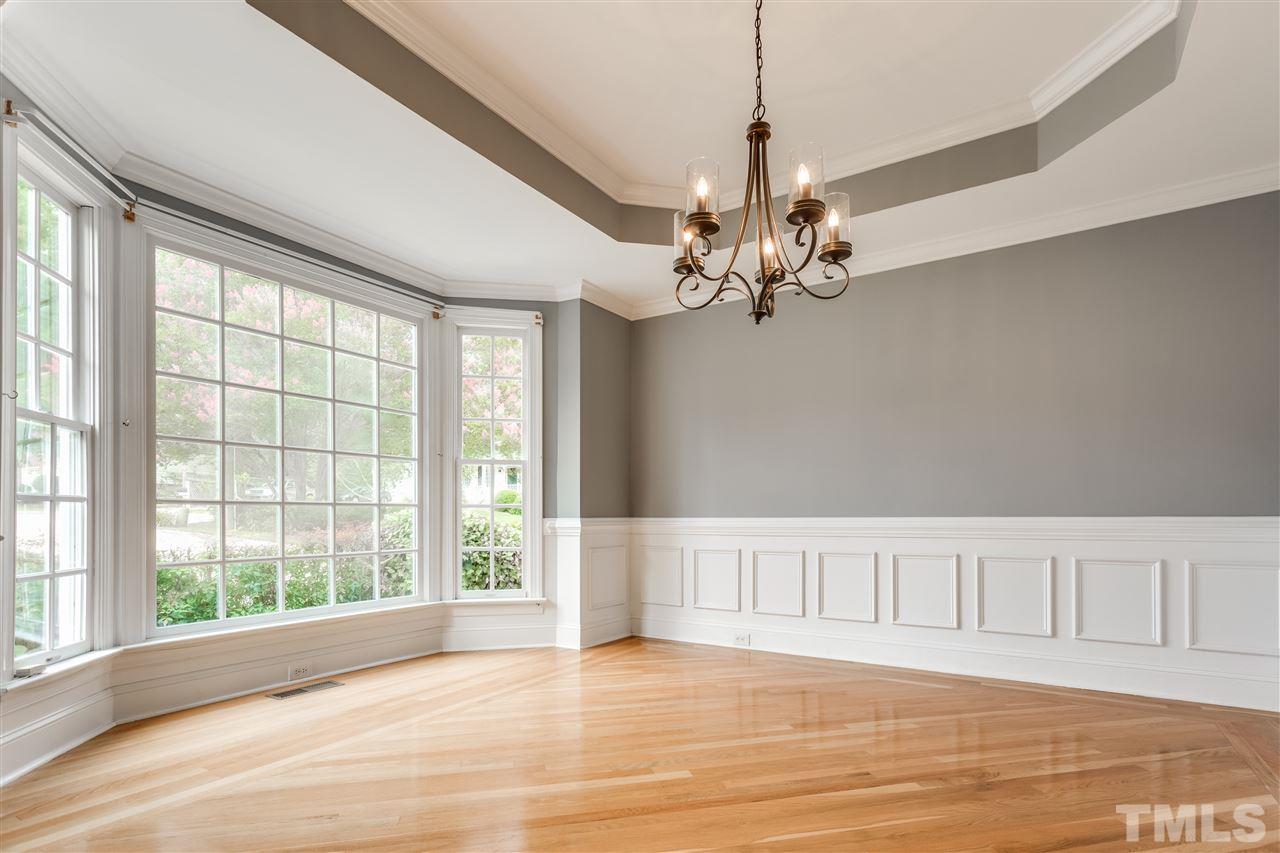 8401 Largo Springs Court Raleigh, NC 27613 - Photo 5 of 25 a view of an empty room with wooden floor and a window
