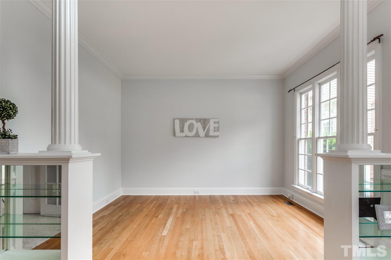 8401 Largo Springs Court Raleigh, NC 27613 - Photo 6 of 25 a view of an empty room with a window and wooden floor