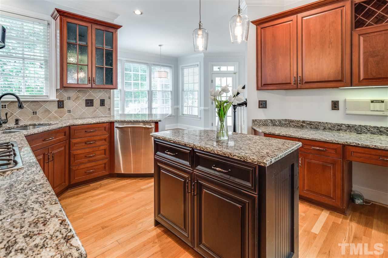 8401 Largo Springs Court Raleigh, NC 27613 - Photo 9 of 25 a kitchen with granite countertop stainless steel appliances and wooden cabinets