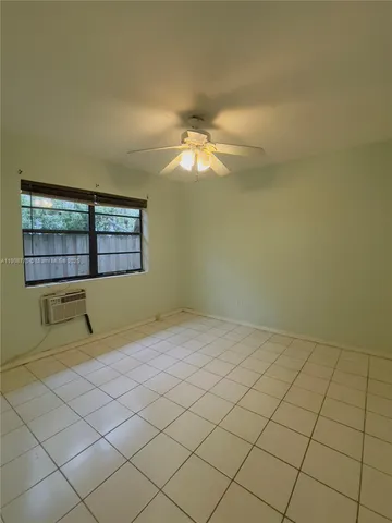 a view of a room with window and a ceiling fan