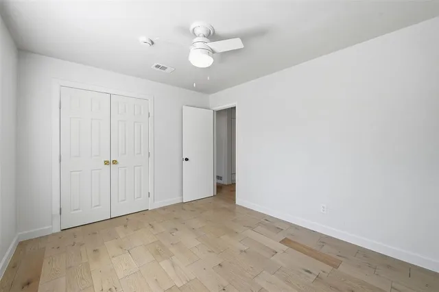a view of a kitchen with a closet and wooden floor