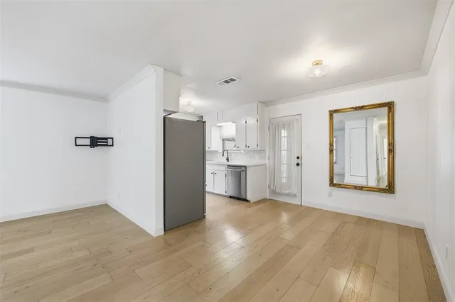 a kitchen with stainless steel appliances a refrigerator and a stove top oven