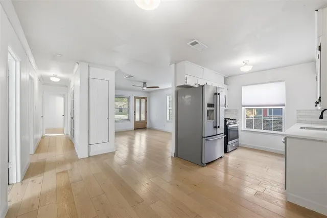 a view of a backyard with wooden floor and fence