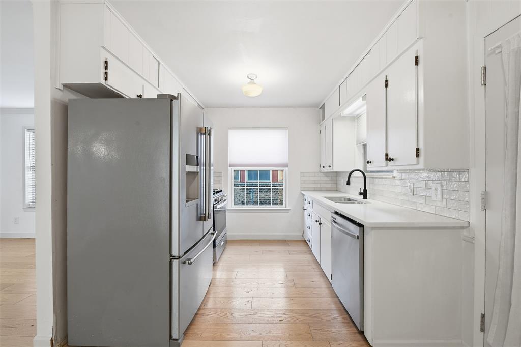 402 Vicki Street Keller, TX 76248 - Photo 2 of 21 a kitchen with a sink a counter top space stainless steel appliances cabinets and a window
