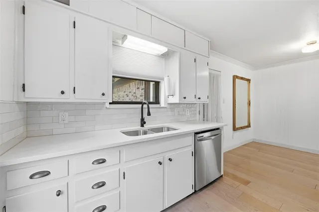 a kitchen with granite countertop white cabinets and white appliances