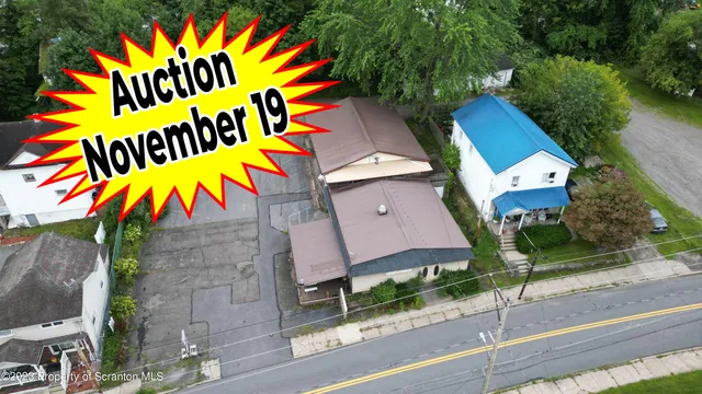 an aerial view of a house with a swimming pool