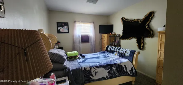 a bedroom with bed and wooden floor