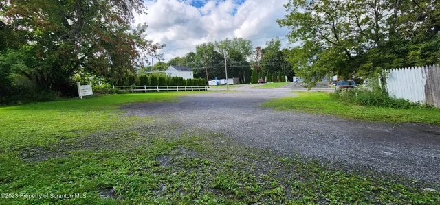 a view of a yard with a house in the background