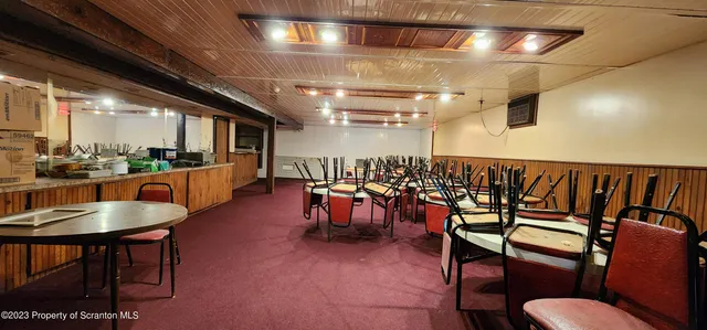 an aerial view of a house with a garden and trees