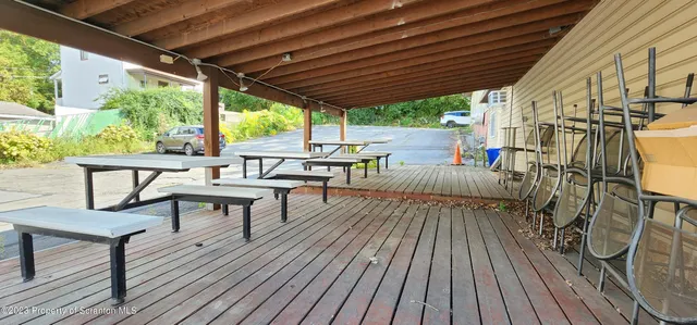 a view of a patio with table and chairs and wooden floor