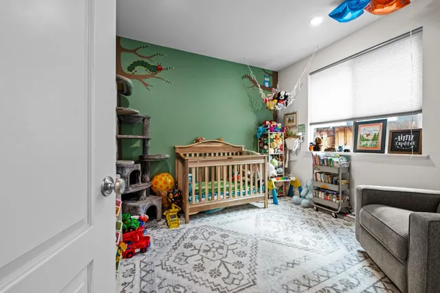 a living room with baby crib and furniture