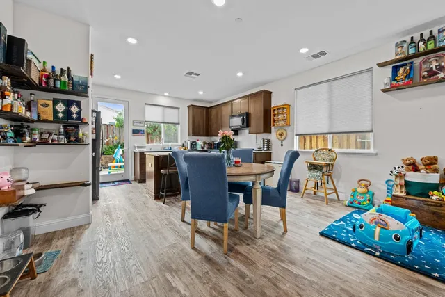 a view of a dining room with furniture and wooden floor