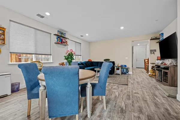 a view of a dining room with furniture and wooden floor