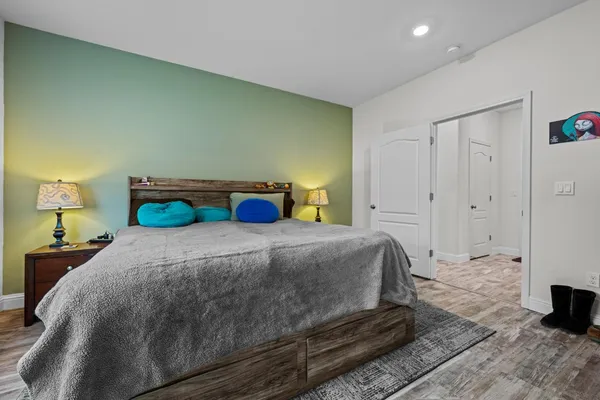 a bedroom with a bed and a flat screen tv