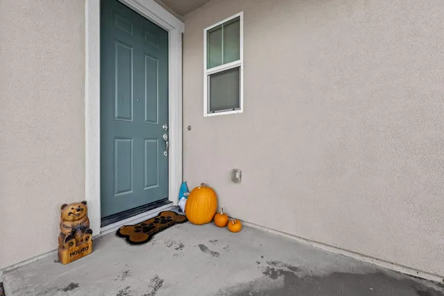 a view of a hallway with wooden floor and windows