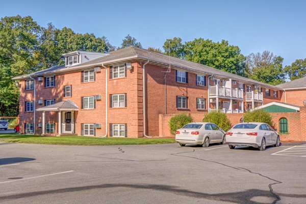 79 Leonard Road, Unit 79 Boxborough, MA 01719 - Photo 1 of 16 a front view of a residential apartment building with a garden
