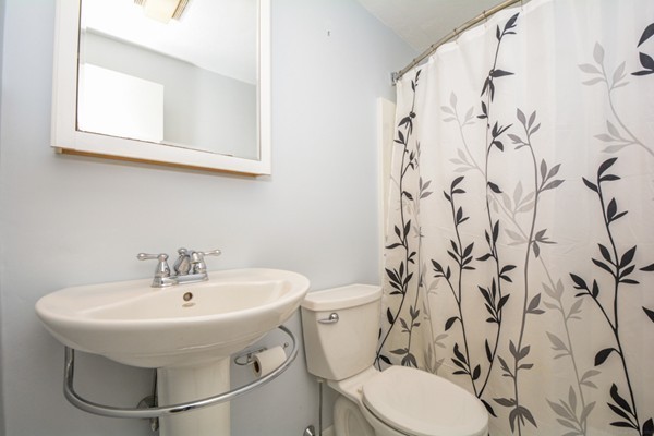 79 Leonard Road, Unit 79 Boxborough, MA 01719 - Photo 11 of 16 a bathroom with a sink and mirror with toilet