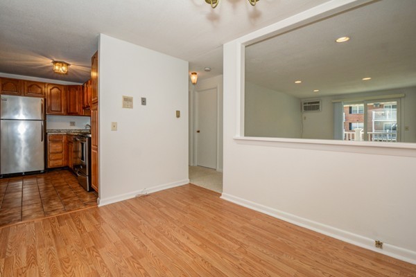 79 Leonard Road, Unit 79 Boxborough, MA 01719 - Photo 5 of 16 a view of a hallway with wooden floor and a living room