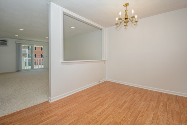 79 Leonard Road, Unit 79 Boxborough, MA 01719 - Photo 6 of 16 wooden floor in an empty room with a window