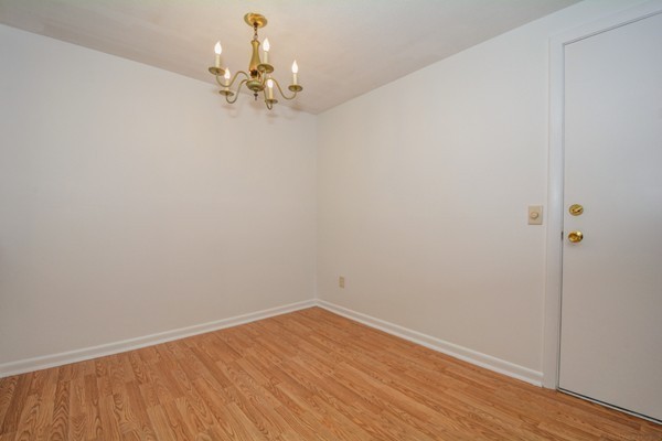 79 Leonard Road, Unit 79 Boxborough, MA 01719 - Photo 7 of 16 a view of a room with wooden floor and chandelier