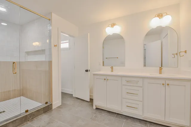 a bathroom with double sink and a mirror