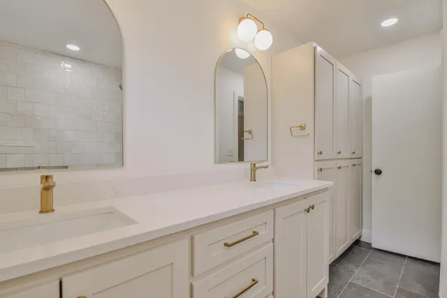 a bathroom with a double vanity sink and a mirror