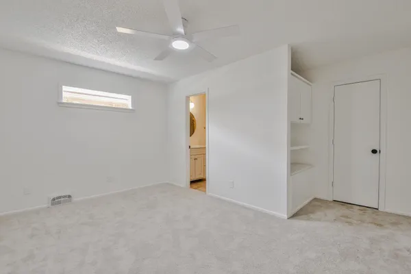 an empty room with windows and closet