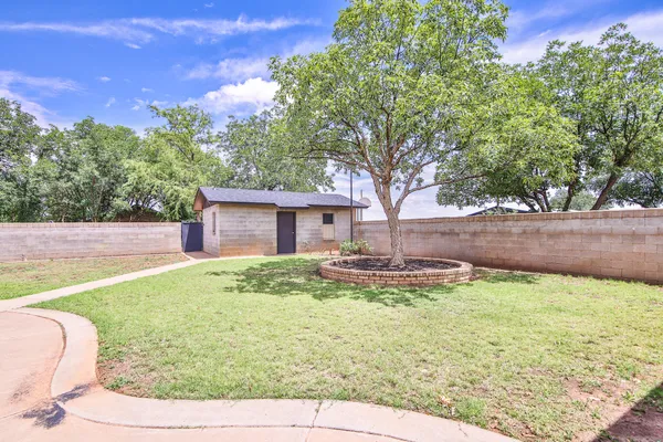 a backyard of a house with yard and outdoor seating