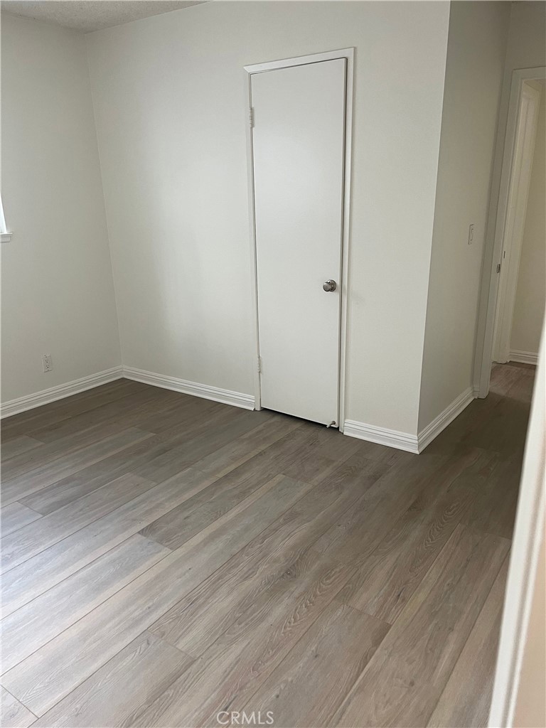 8721 Squires Circle Huntington Beach, CA 92646 - Photo 14 of 43 an empty room with wooden floor and closet