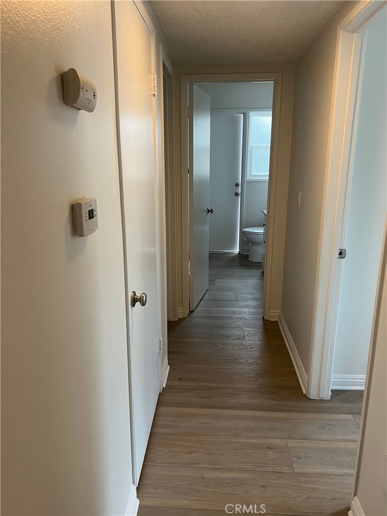 8721 Squires Circle Huntington Beach, CA 92646 - Photo 18 of 43 a view of a hallway with wooden floor