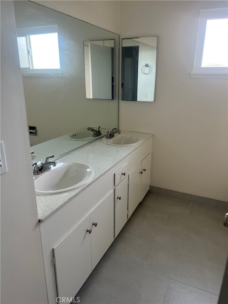 8721 Squires Circle Huntington Beach, CA 92646 - Photo 20 of 43 a bathroom with a sink and a mirror
