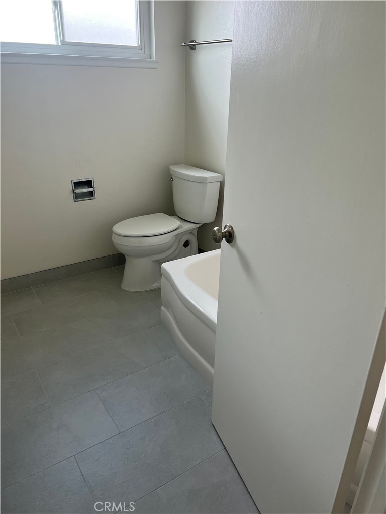 8721 Squires Circle Huntington Beach, CA 92646 - Photo 21 of 43 a white toilet sitting next to a white cabinet