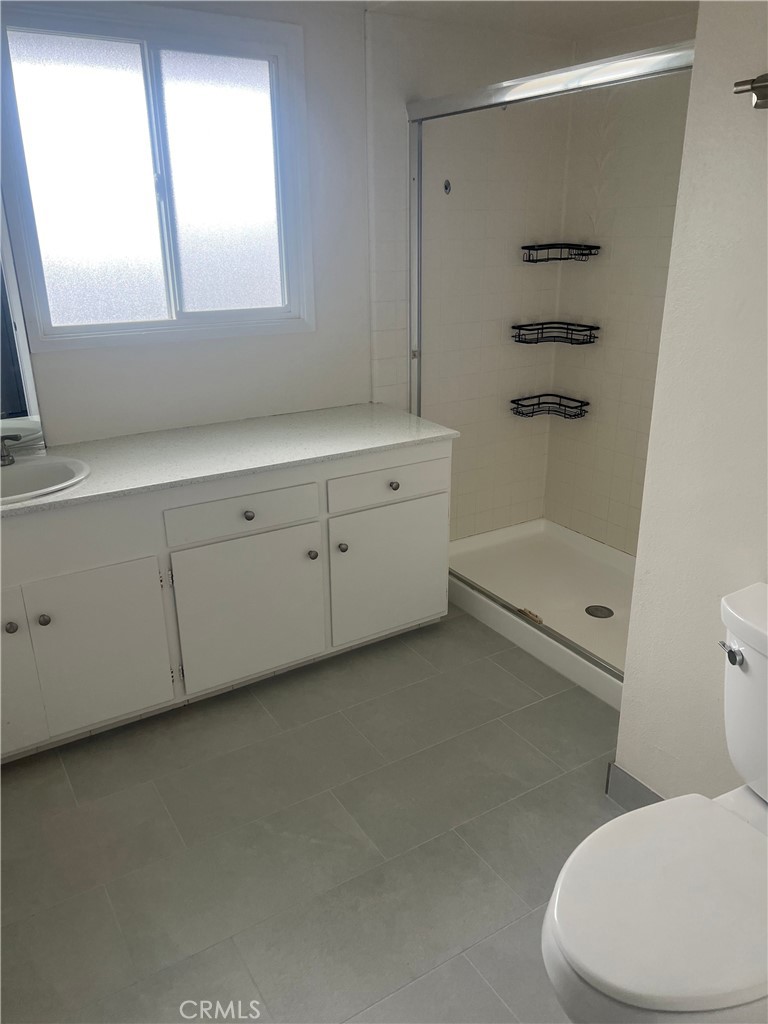 8721 Squires Circle Huntington Beach, CA 92646 - Photo 37 of 43 a bathroom with a sink a toilet and shower