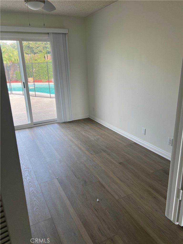 8721 Squires Circle Huntington Beach, CA 92646 - Photo 4 of 43 an empty room with wooden floor and windows