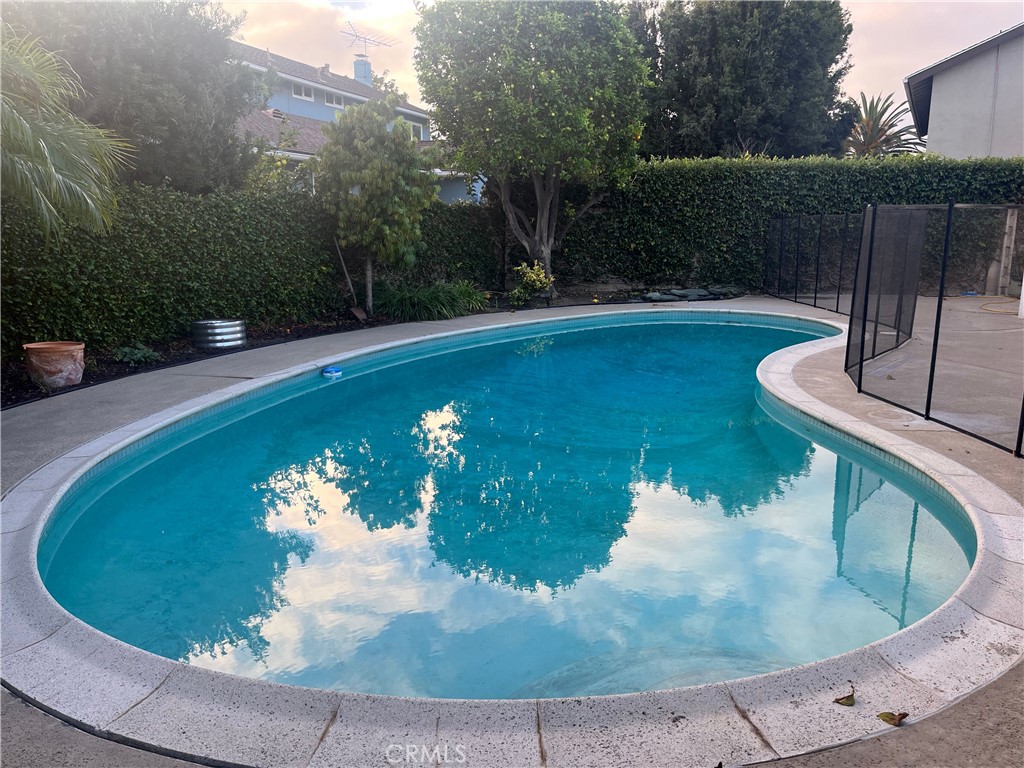 8721 Squires Circle Huntington Beach, CA 92646 - Photo 41 of 43 a view of a swimming pool with a yard