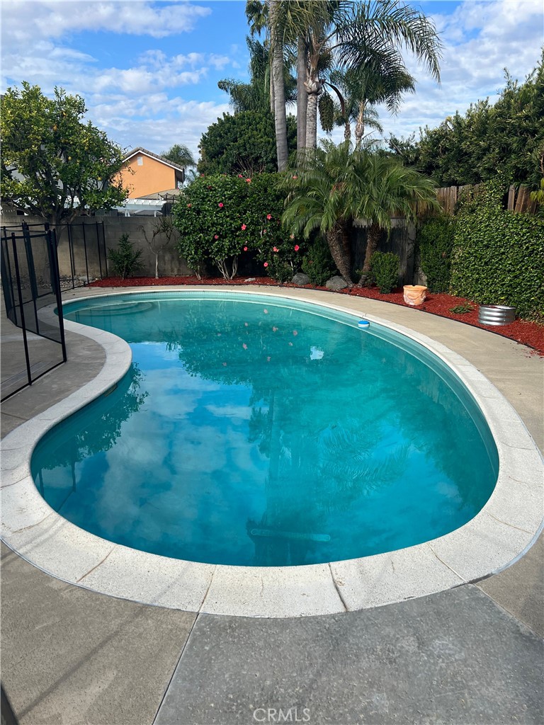 8721 Squires Circle Huntington Beach, CA 92646 - Photo 42 of 43 a view of a swimming pool with a yard