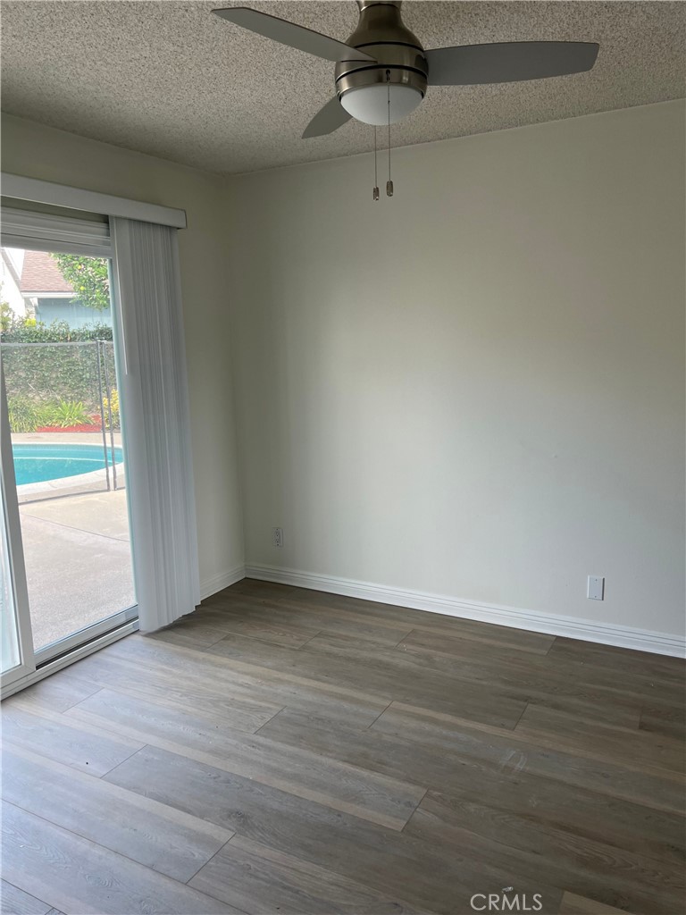 8721 Squires Circle Huntington Beach, CA 92646 - Photo 5 of 43 wooden floor in an empty room with a window
