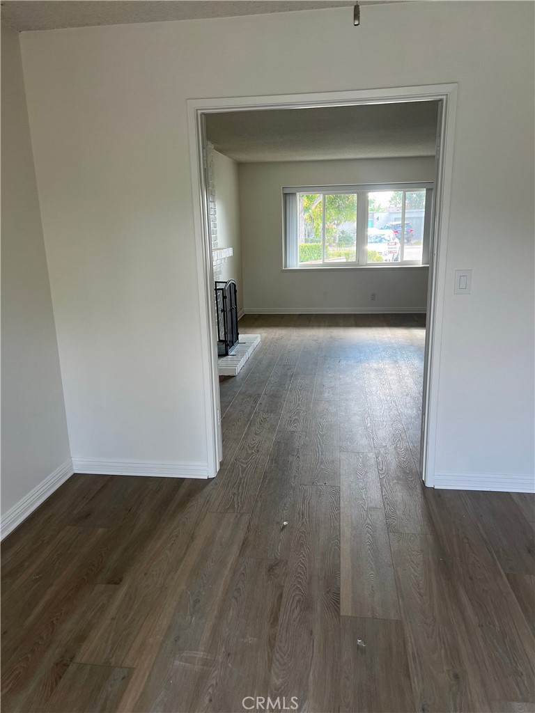 8721 Squires Circle Huntington Beach, CA 92646 - Photo 6 of 43 an empty room with wooden floor and a window
