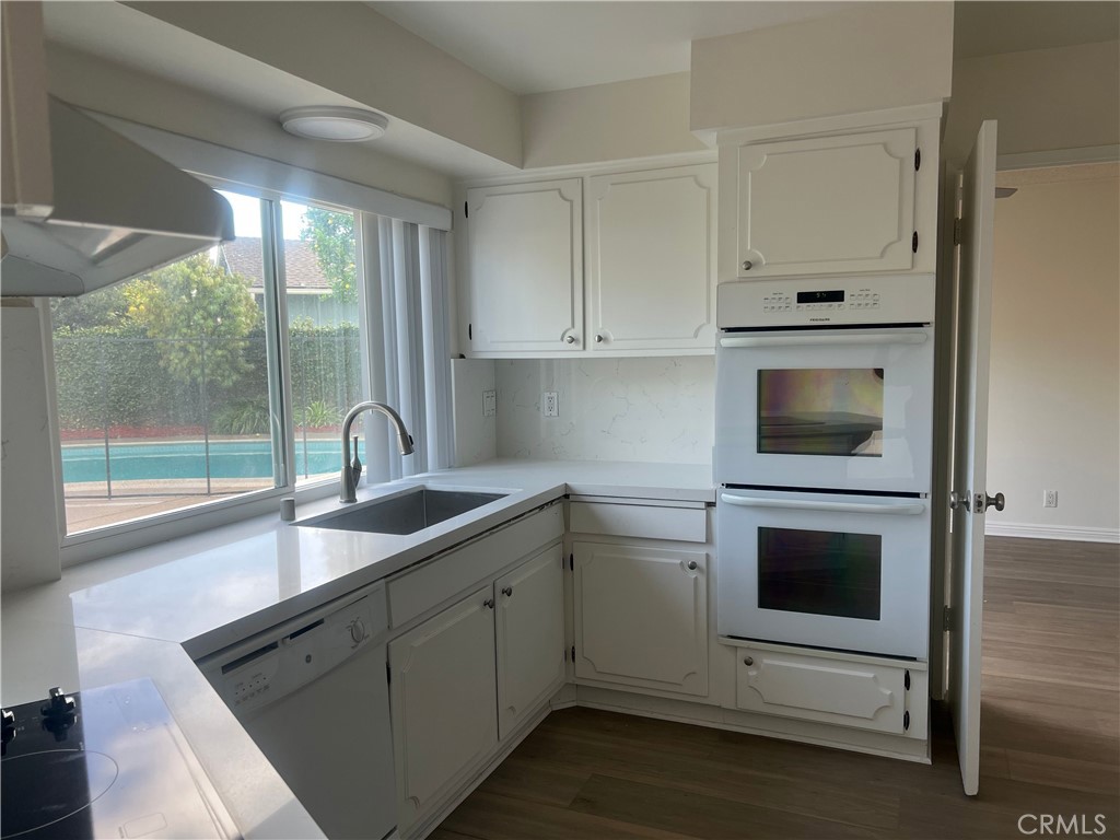 8721 Squires Circle Huntington Beach, CA 92646 - Photo 7 of 43 a kitchen with a sink and a microwave