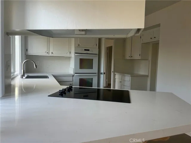 a kitchen with kitchen island a counter top space and cabinets