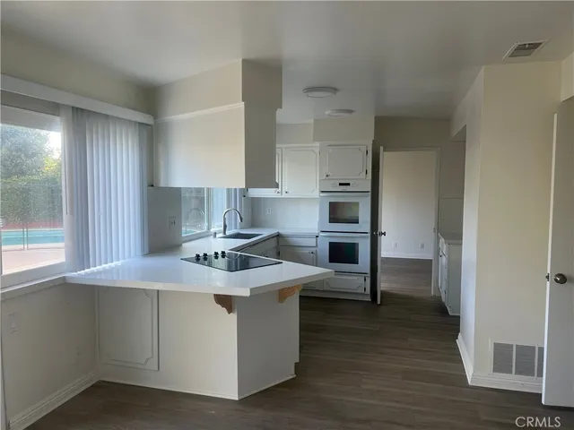 a kitchen with stainless steel appliances granite countertop a stove and a refrigerator